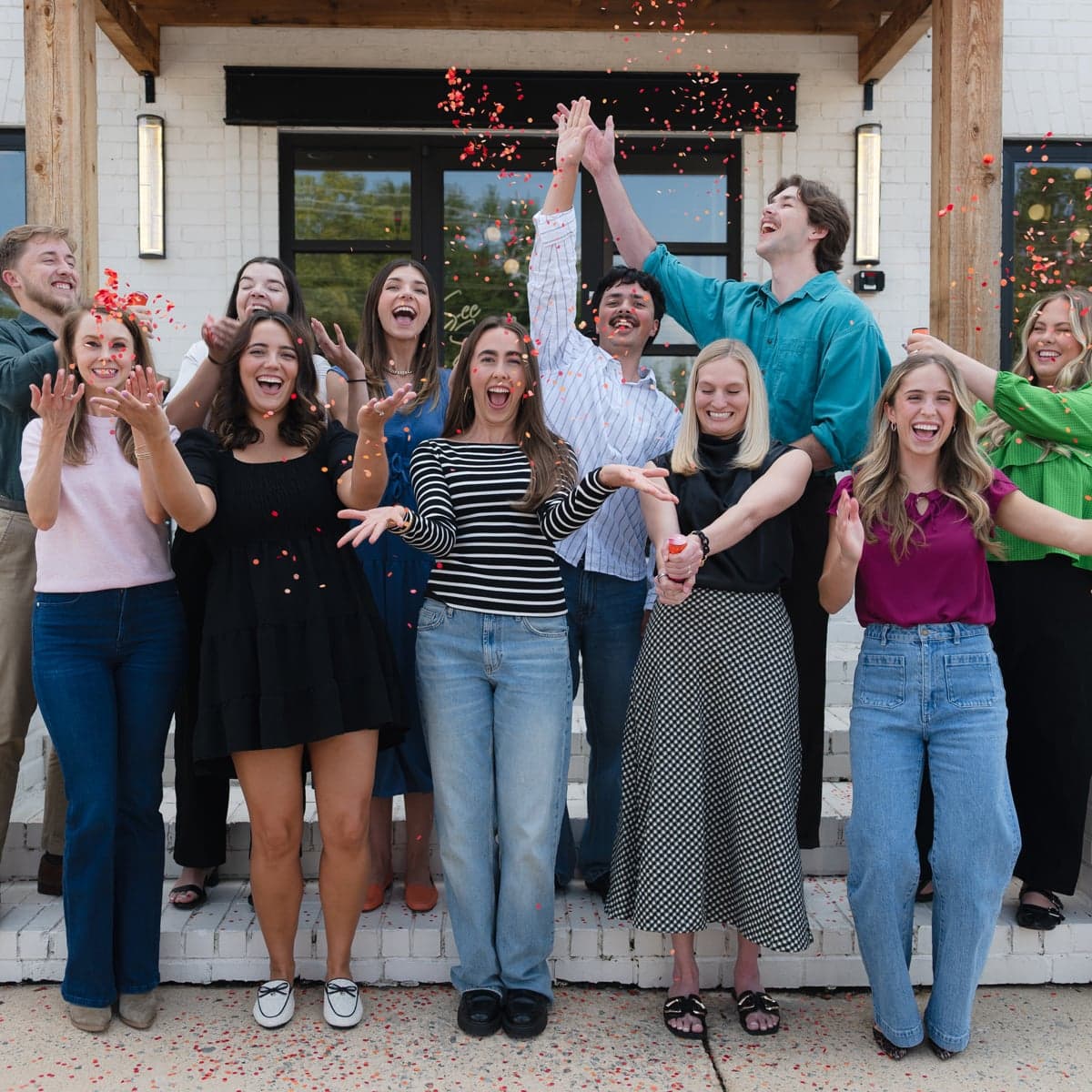 Members of the See Spark Go team celebrating together outside their office